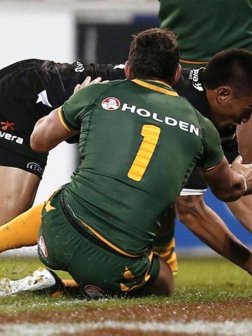New Zealand's Dean Whare  crosses the line as Australia's Billy Slater attempts to tackle him...