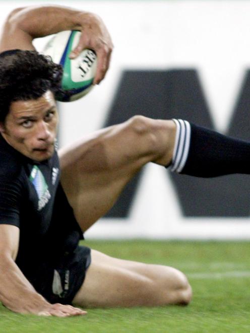 New Zealand's Doug Howlett scores a try during the Rugby World Cup game against Wales at Sydney's...