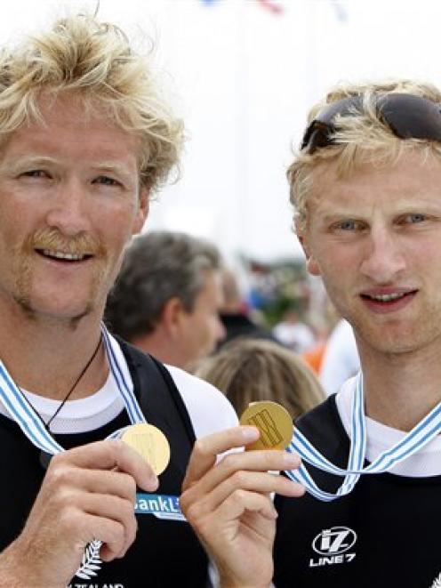 New Zealand's gold medalists Hamish Bond, right, and Eric Murray, left, pose after the medal...