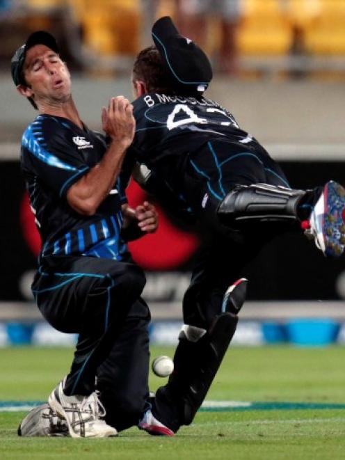 New Zealand's Grant Elliott (L) and Brendon McCullum collide as they try to make a catch during...