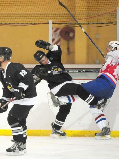 New Zealand's Hayden Argyle (centre) battles with Luxembourg's Benny Welter at the third division...