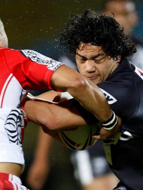 New Zealand's Issac Luke is tackled by Tonga's Eddie Paea. Credit:NZPA / Wayne Drought