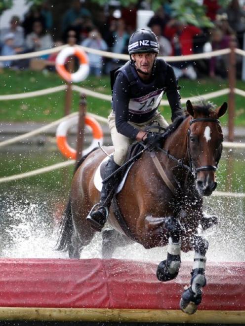 New Zealand's Mark Todd riding Campino takes on the water jumps during the individual eventing...