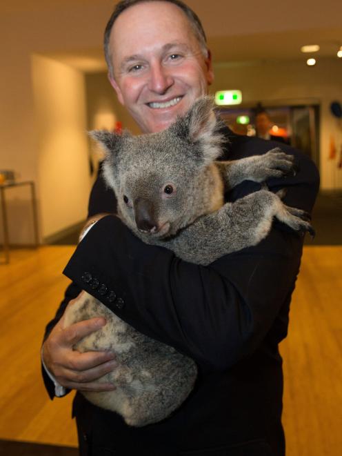 New Zealand's Prime Minister John Key holds a koala before the G20 Leaders' Summit in Brisbane in...