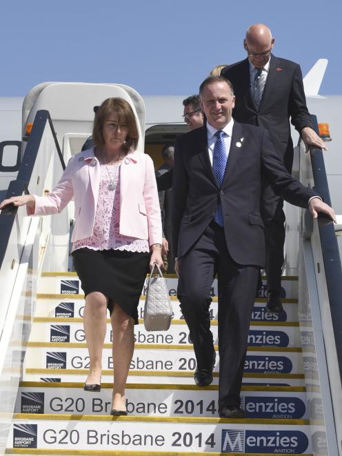 New Zealand's Prime Minister John Key (R) and wife Bronagh arrive at the G20 Terminal in Brisbane...