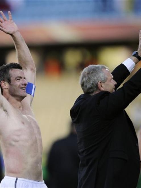 New Zealand's Ryan Nelsen, left, and New Zealand coach Ricki Herbert, right, salute New Zealand...