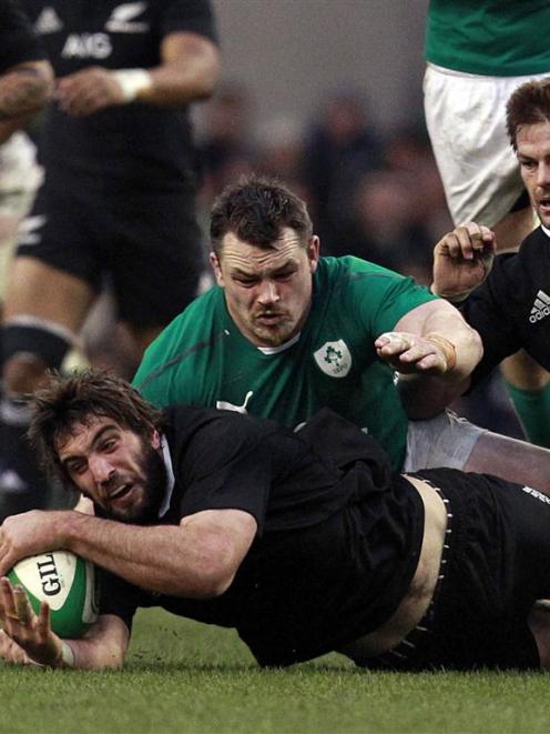 New Zealand's Sam Whitelock is challenged by Ireland's Cian Healy. REUTERS/Cathal McNaughton