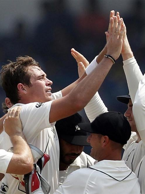 New Zealand's Tim Southee celebrates with teammates after taking the wicket of Sri Lanka's Thilan...