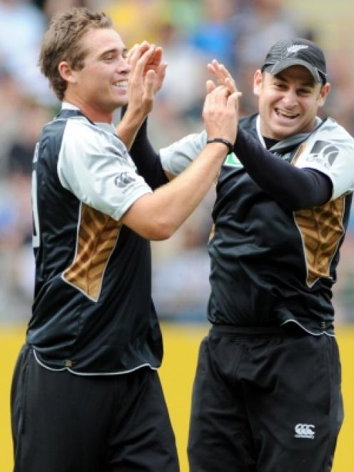 New Zealand's Tim Southee, left celebrates with Nathan McCullum after taking the wicket of...