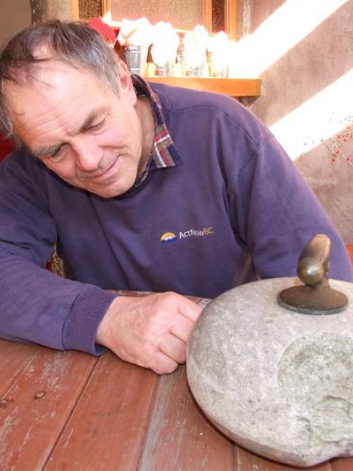 New Zealand senior curling skip Peter Becker, of Patearoa, with a stone believed to have been...