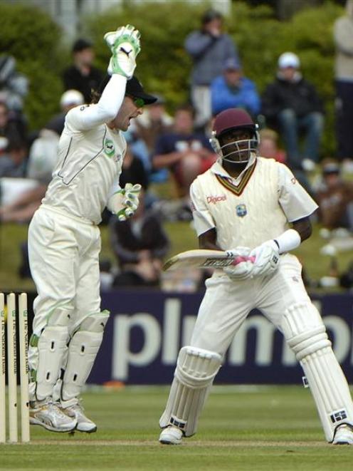 New Zealand wicketkeeper Brendon McCullum celebrates taking the catch to dismiss West Indies...