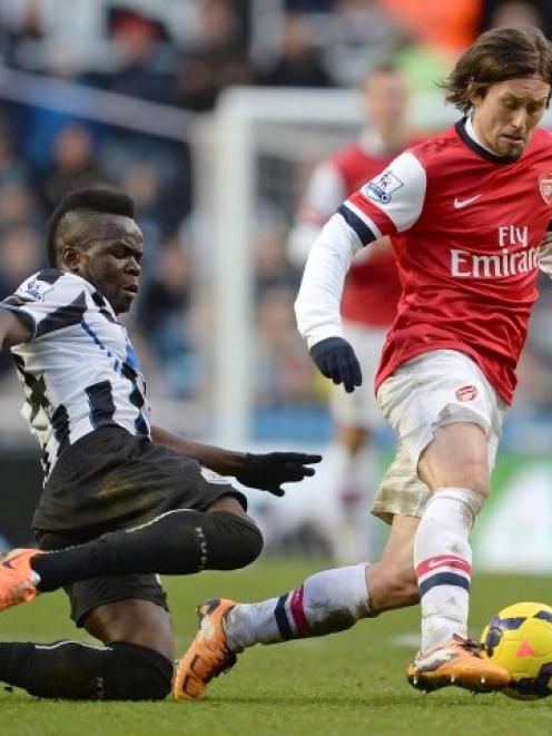 Newcastle United's Cheick Tiote (L) challenges Arsenal's Tomas Rosicky during their match at St...