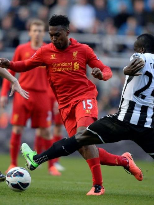 Newcastle United's Yohan Cabaye (L) and Chieck Tiote challenge Liverpool's Daniel Sturridge...