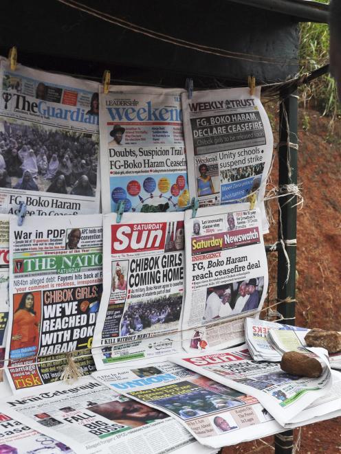 Newspapers with various front page headlines on the Chibok girls and their possible release are...
