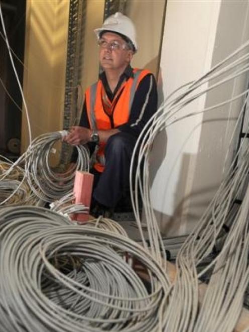 NHNZ technical and IT systems manager Wayne Poll inspects some of the 25km of cabling which is...