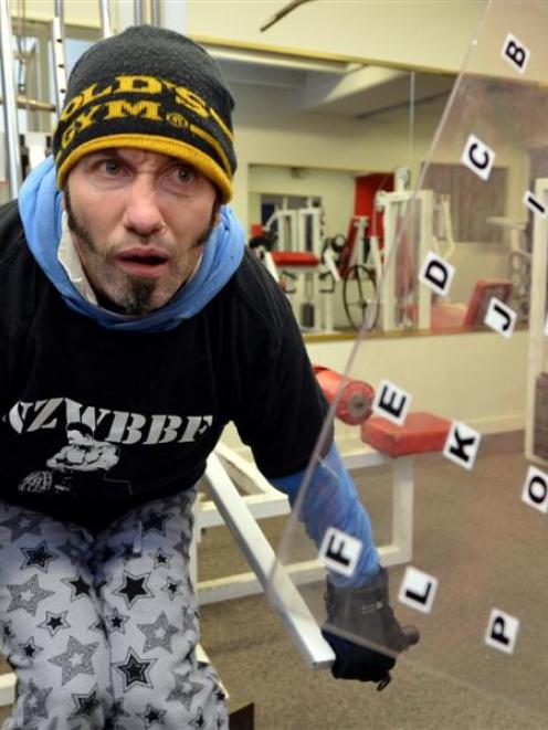 Nick Chisholm works  while communicating with trainer Shane Waldron through an alphabet grid....