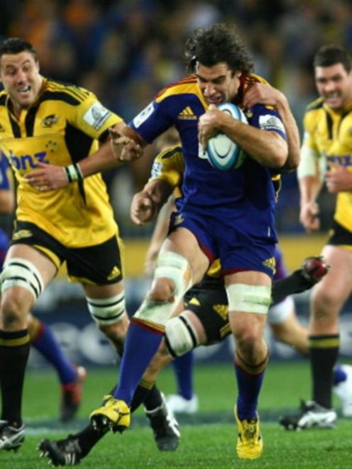 Nick Crosswell of the Highlanders tries to break a tackle.  (Photo by Teaukura Moetaua/Getty Images)