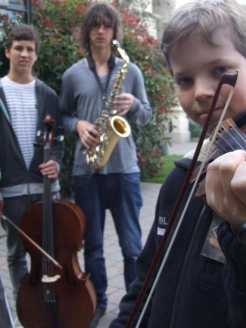 Nick Majic (13) plays his violin at Waitaki Boys' High School yesterday, watched by his brothers...