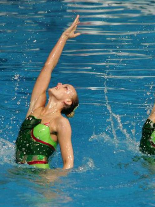Nina (left) and Lisa Daniels compete in duel synchronised swimming. Photo from ODT files.