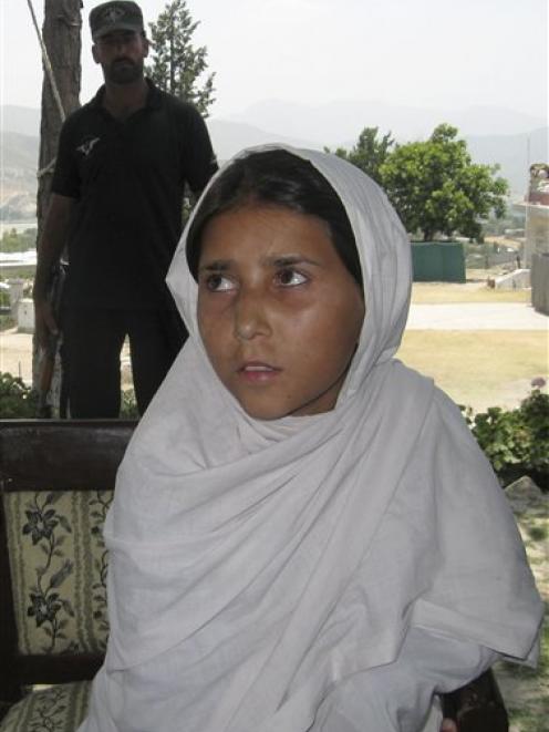 Nine-year-old Sohana Jawed sits during a news conference in Lower Dir in Timergarah, Pakistan on...