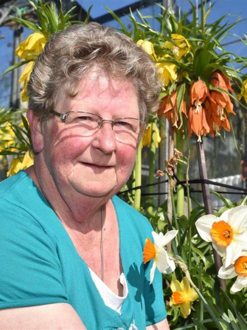 Nola Coburn in her garden with her flowering crown imperial fritillaries. Photo by Gregor...