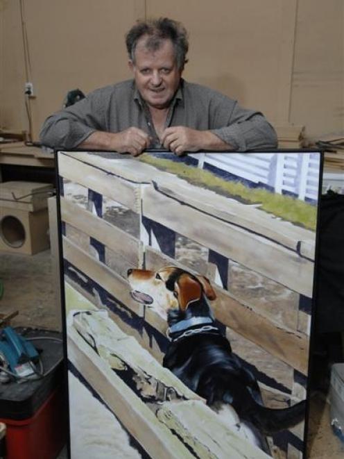 Norman Sinclair with one of his paintings of a huntaway dog,  <i>Roy In The Yards</i>. Photo by...