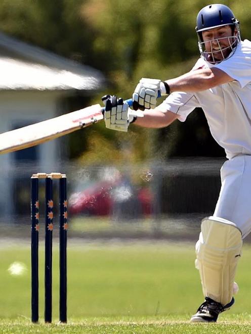 North East Valley batsman Andrew Sim reaches for a delivery during his side’s match against...