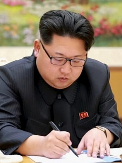 North Korean leader Kim Jong Un signs a document regarding the test of a hydrogen bomb. Photo:...