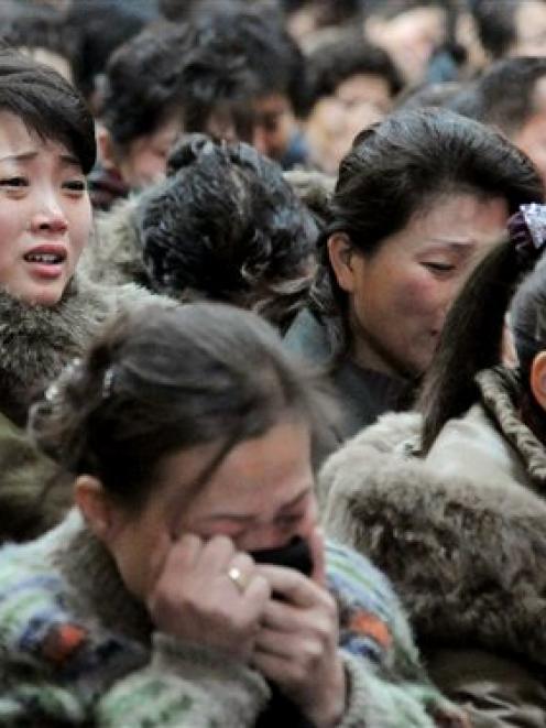 North Korean women cry after learning death of their leader Kim Jong-il yesterday. (AP Photo...