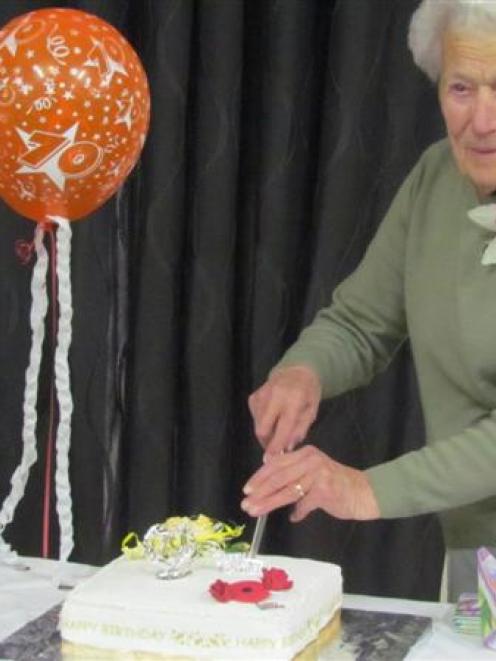 North Oamaru RSA Women's Section past president Joan Williams cuts the cake, during celebrations...