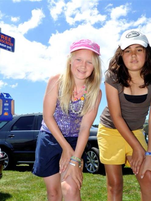 North Taieri 10-year-olds Britany Howorth (left) and Angel Kiriau apply sunscreen during the...