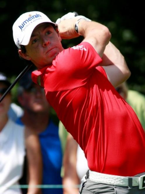 Northern Ireland golfer Rory McIlroy hits a drive on the second tee during round one of the BMW...