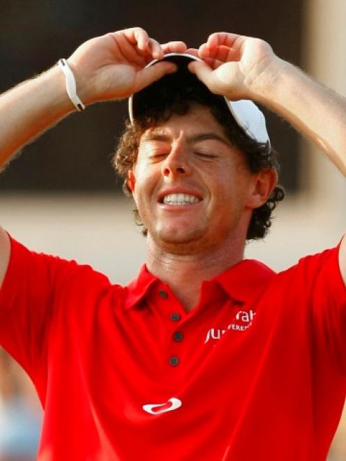 Northern Irish golfer Rory McIlroy reacts on the 18th green after winning the PGA Championship at...