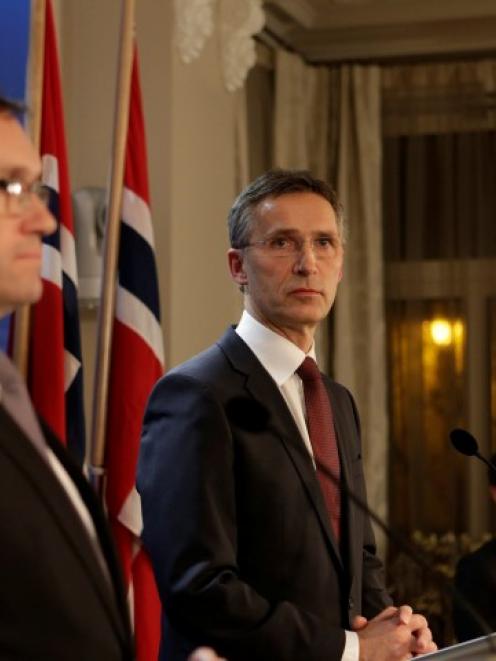Norway's Prime Minister Jens Stoltenberg (C) and Minister of Foreign Affairs Espen Barth Eide...