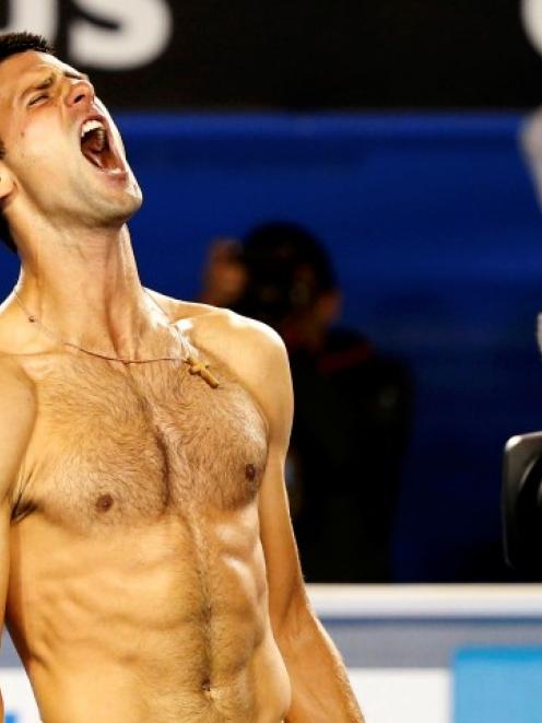 Novak Djokovic of Serbia celebrates defeating Stanislas Wawrinka of Switzerland in their men's...