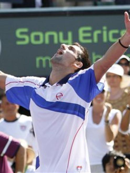 Novak Djokovic, of Serbia, celebrates his win against Rafael Nadal, of Spain, in the men's final...