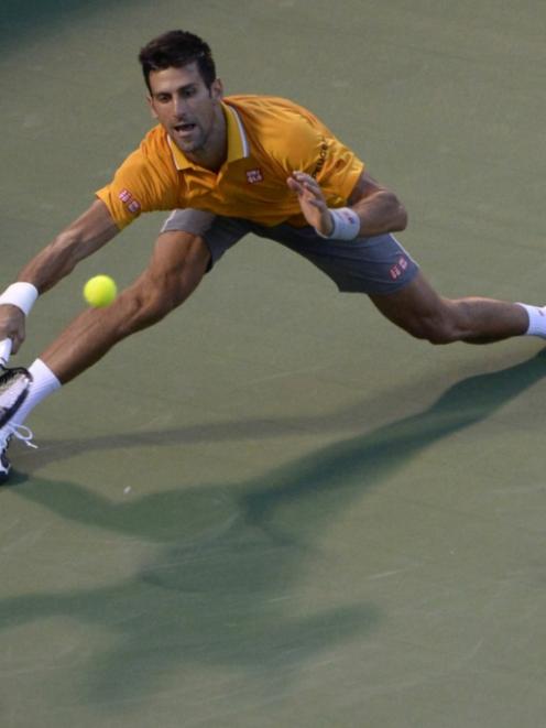 Novak Djokovic reaches to play a shot in his win over Thomaz Bellucci at the Rogers Cup. Photo by...