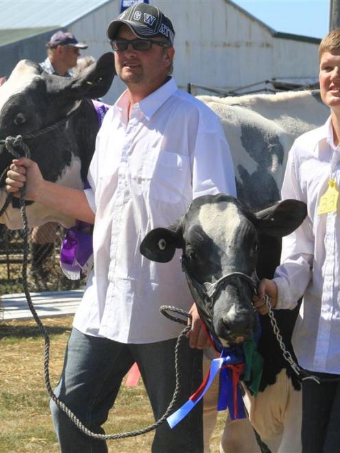 Oamaru dairy farmers Rob Kelly (left) with Candy, and Jason Kelly (14), with Licorice, take part...