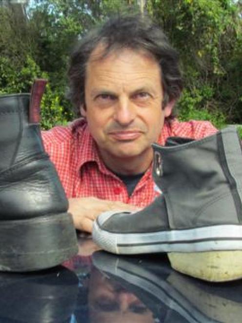 Oamaru man John Baster compares the boots altered by McKinlays Footwear of Dunedin (left) to the...