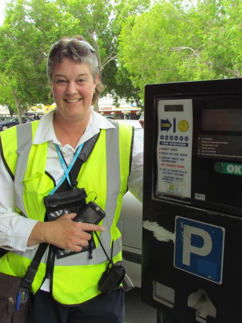 Oamaru parking warden Tania  with one of the town's outdated parking meters. Photo by Andrew Ashton.