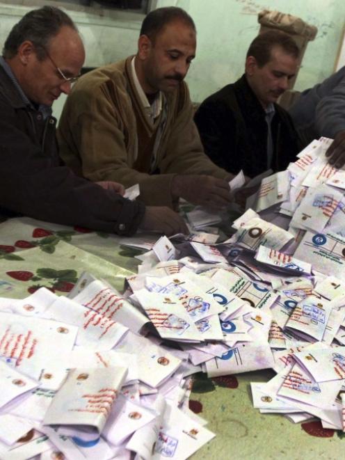 Officials count ballots after polls closed in Bani Sweif, about 115km south of Cairo. Photo by...