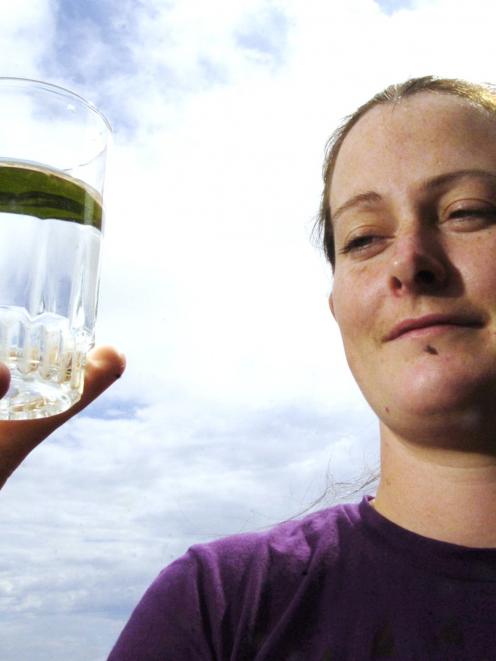 Olive McRae holds a glass of non-fluoridated water. Photo by Gerard O'Brien.