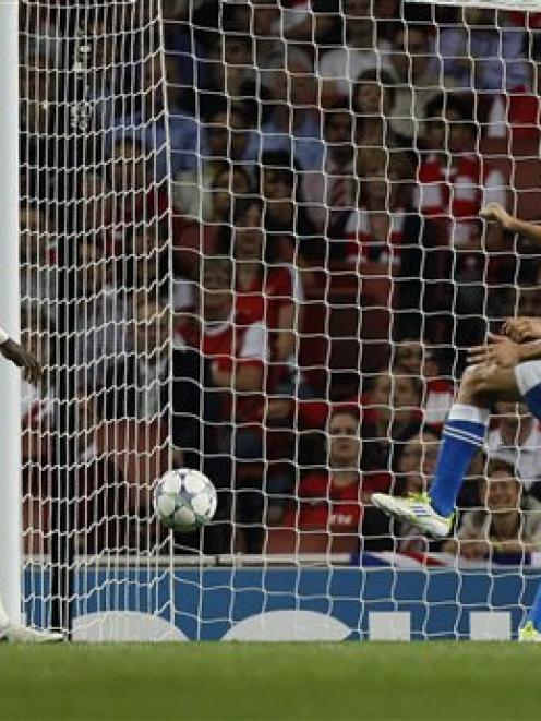 Olympiakos' David Fuster, far right, scores against Arsenal during their Champions League group F...