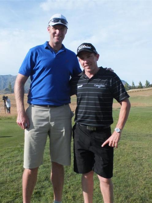 Olympic rower Mahe Drysdale (left) stands with his coach and caddy Guy Wilson before teeing off...
