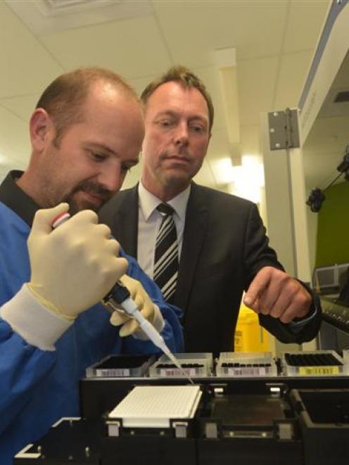 On task are (from left) Pacific Edge chief executive David Darling, senior scientist Justin...