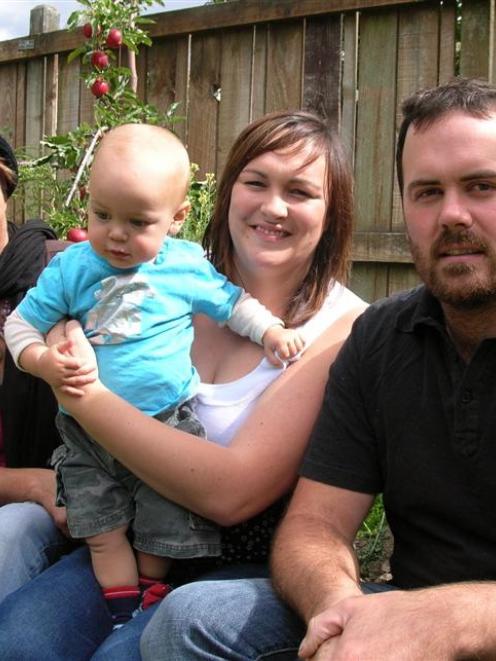One-year-old Mackye Salmon is happy to be home with his family (from left), grandmother Lynda...