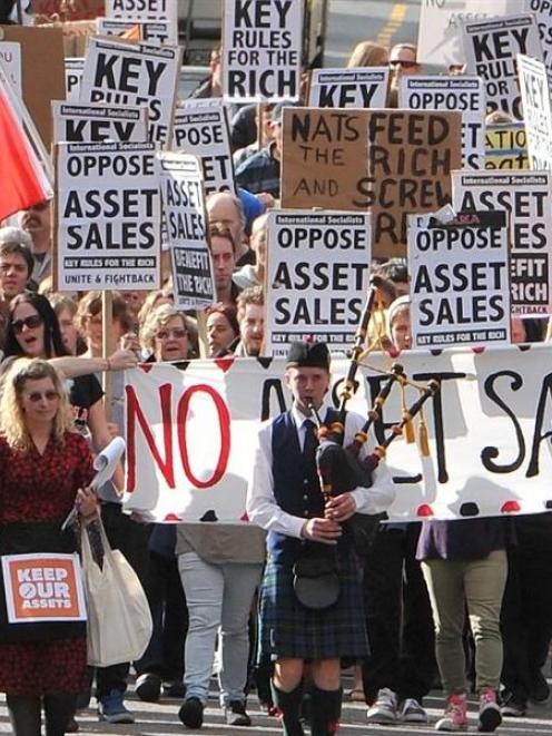 Opponents of state asset sales march down George St on Saturday before a rally in the Octagon....