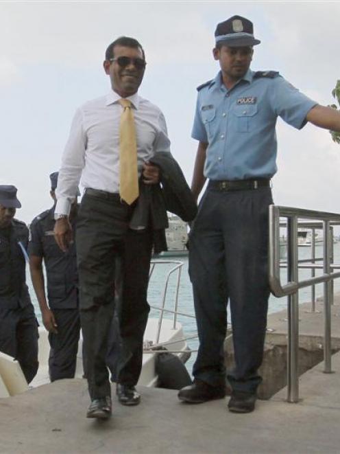Opposition leader and former Maldives president Mohamed Nasheed arrives at Male City with police...