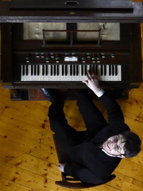 Organist Simon Mace practises on the Alexandre harmonium on Thursday ahead of next week's City of...