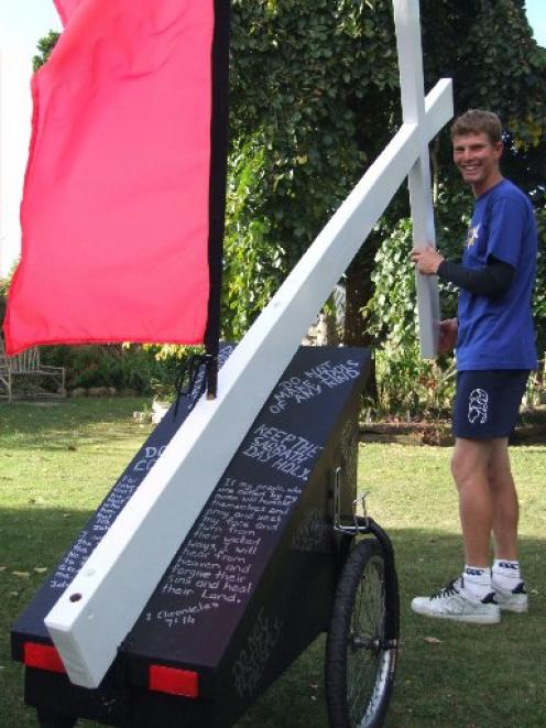 Man on a mission... Ryan Craig with the cross that he will bring journeying from the Bluff to Cape Reinga.  Photo by Sally Rae